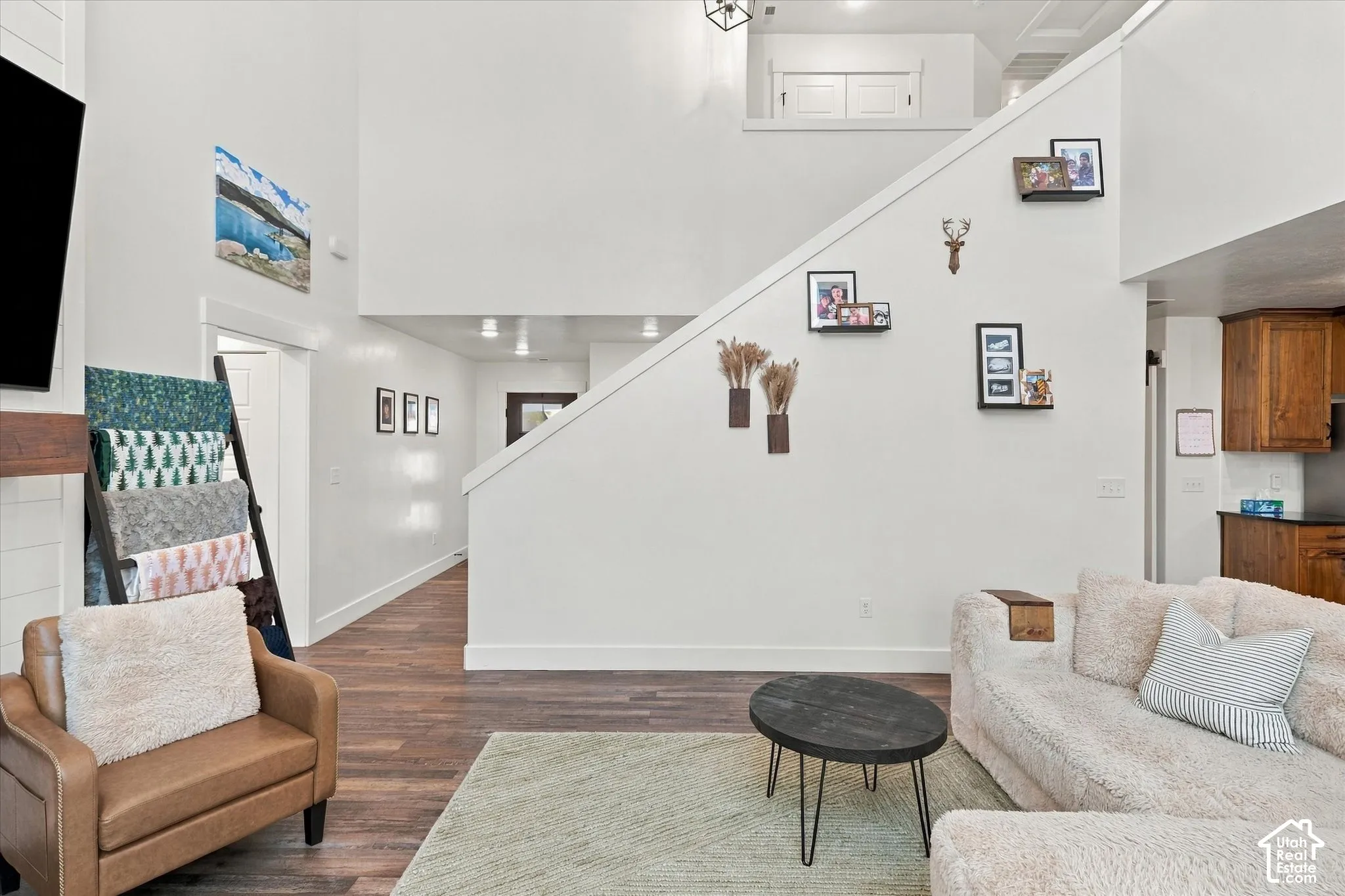 Hardwood-finish flooring, recessed lighting, and a neutral color palette
