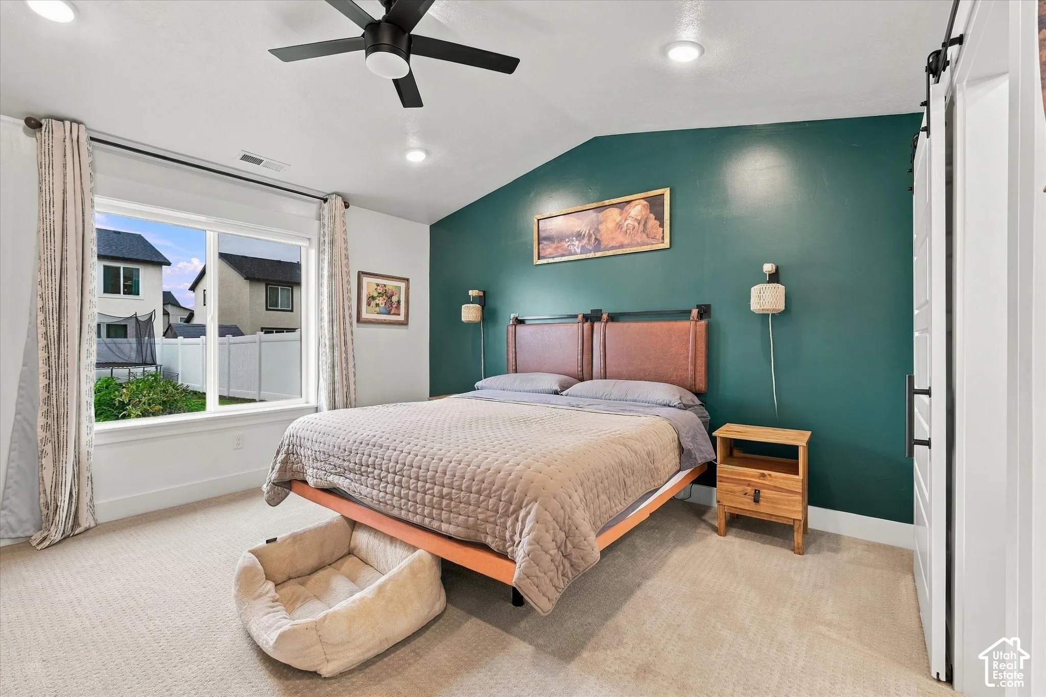 Vaulted ceiling with recessed lighting and a ceiling fan