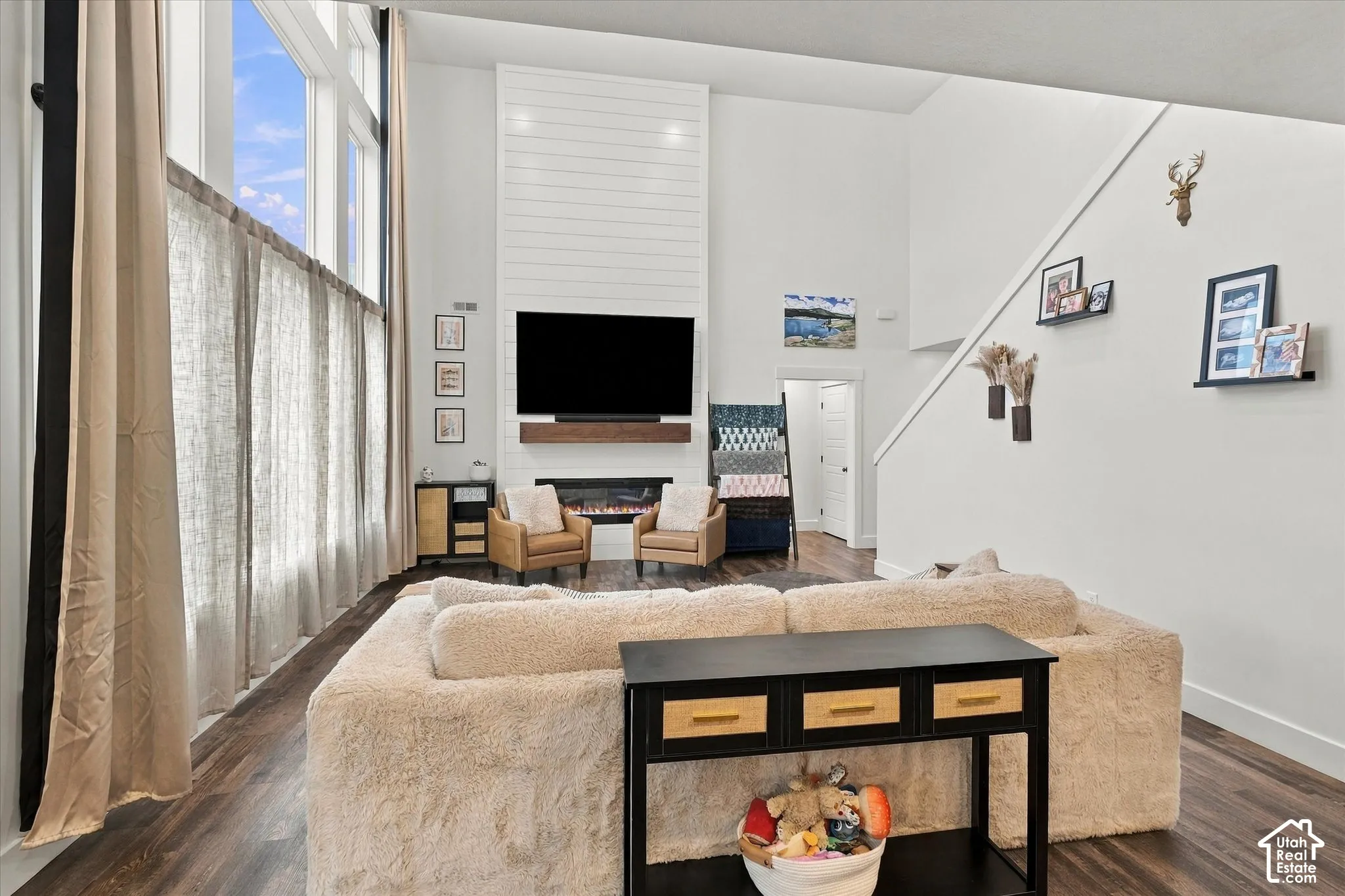 Soaring ceilings and large-format windows enhance the bright living area