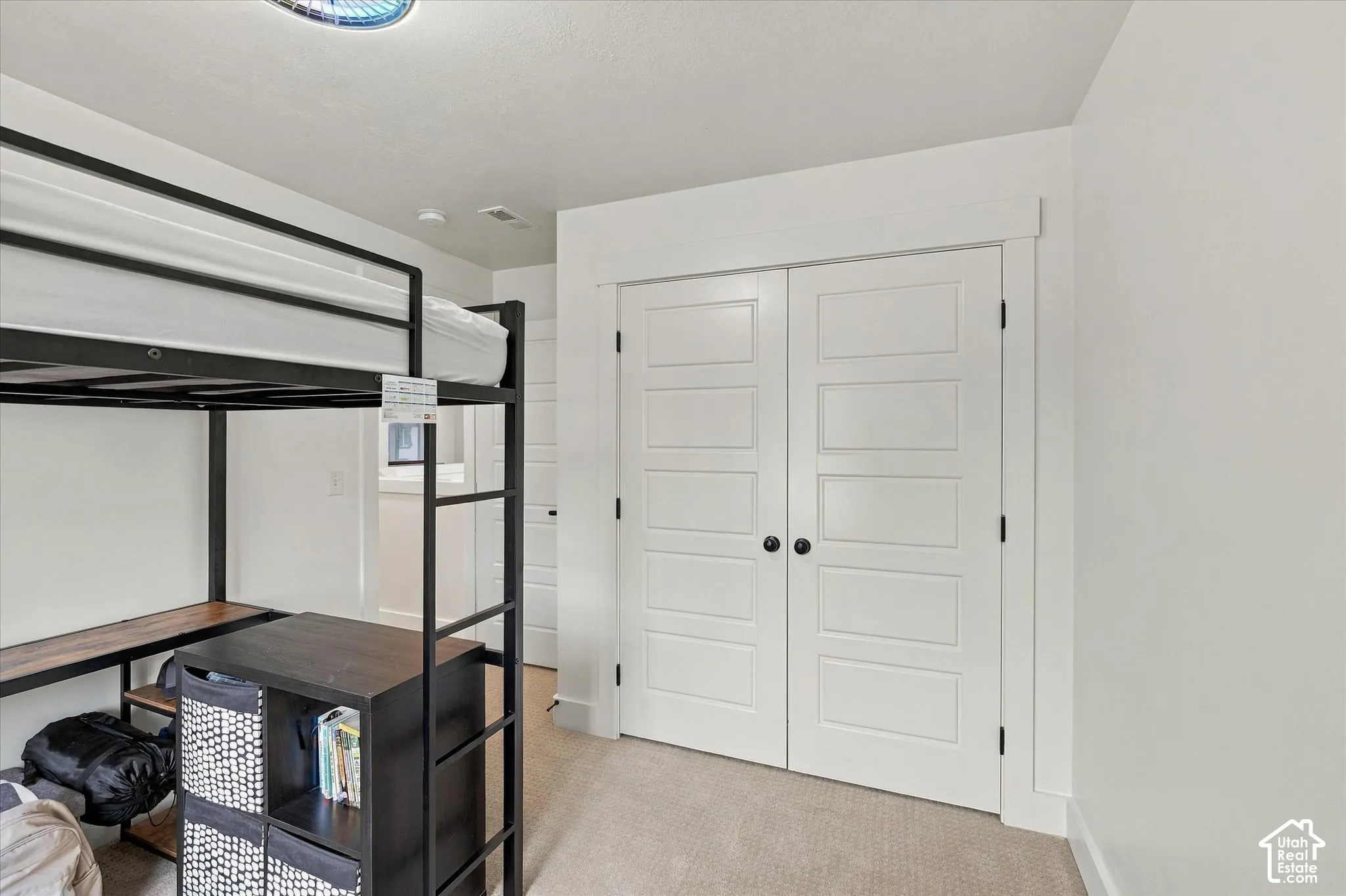 White five-panel closet doors with matte black hardware