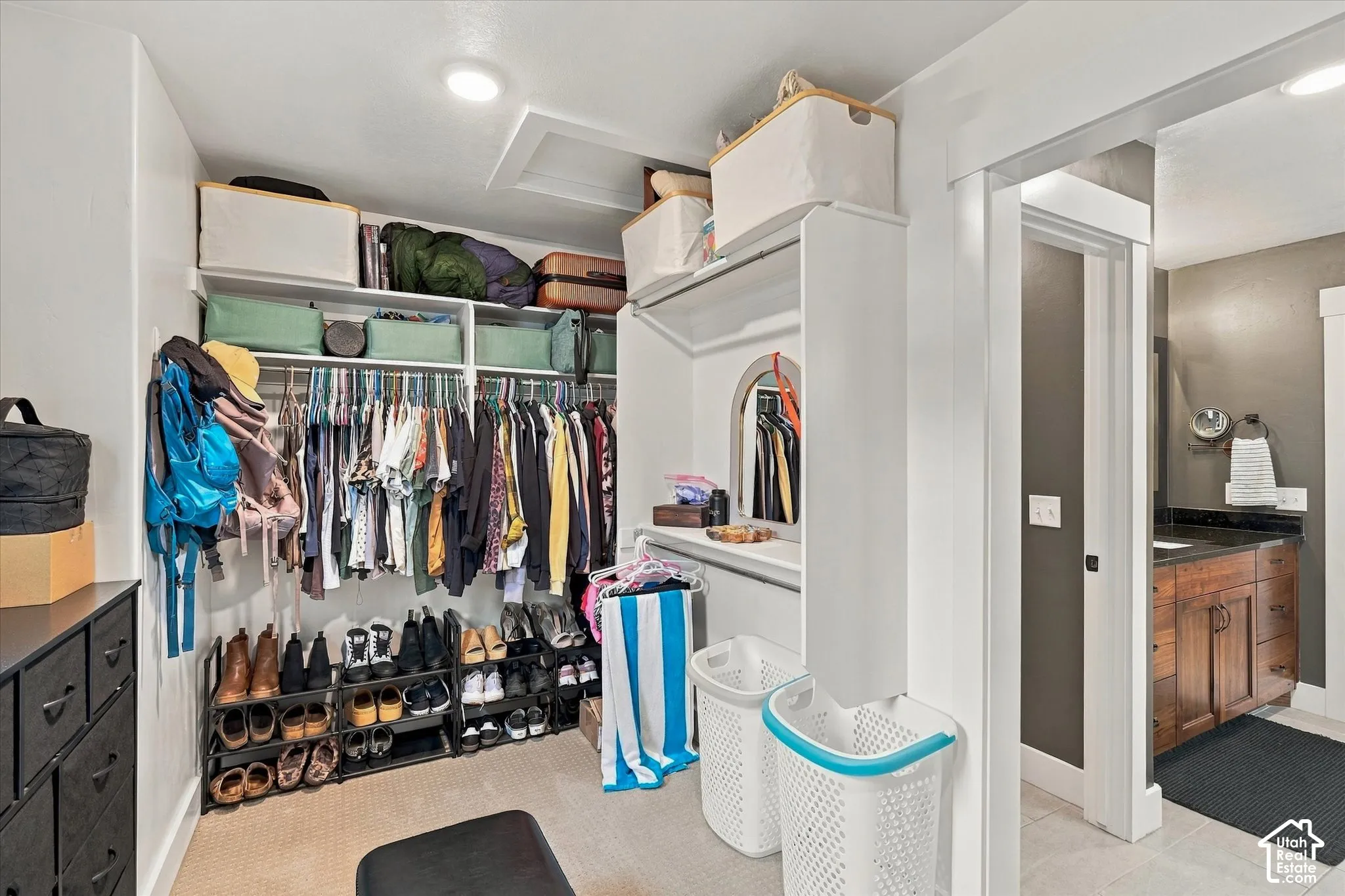 Custom closet system featuring shelving, hanging rods, and an arched niche