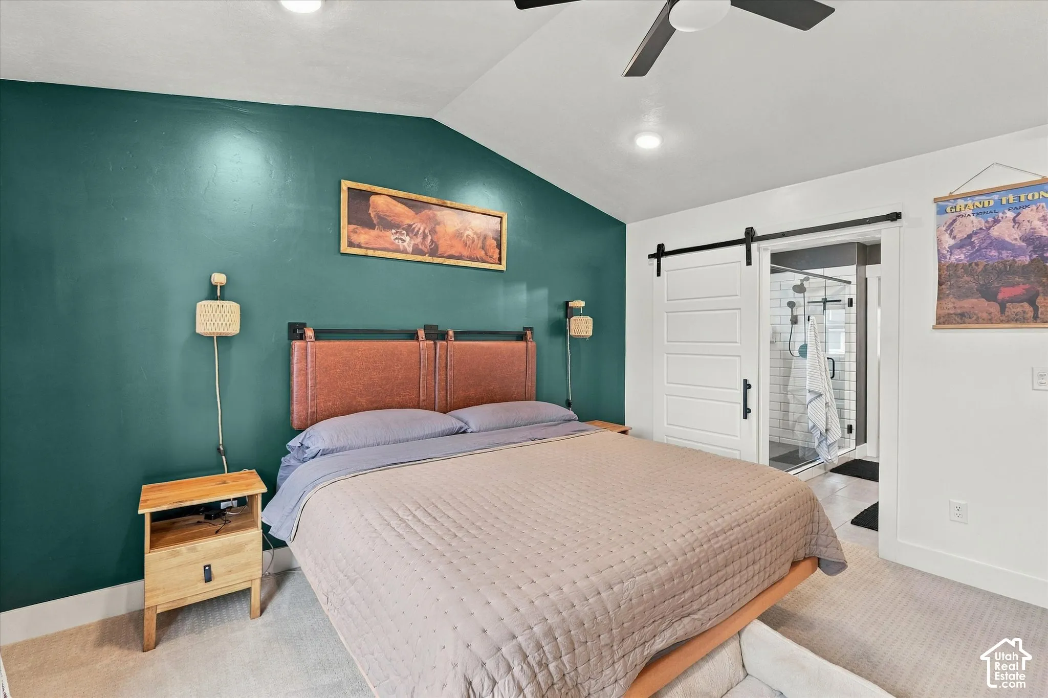 Vaulted ceiling with recessed lighting, ceiling fan, accent wall, and a sliding barn door