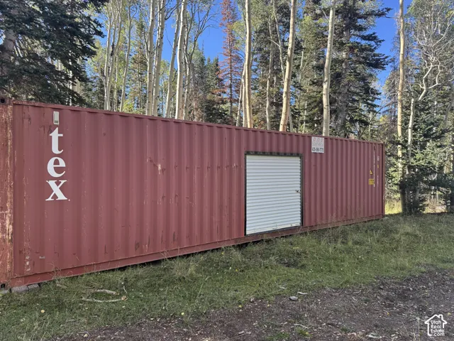 Red corrugated metal exterior with a white roll-up door