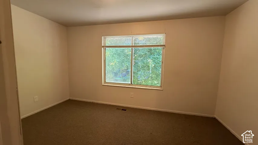Carpeted flooring, neutral wall tones, and a window with blinds