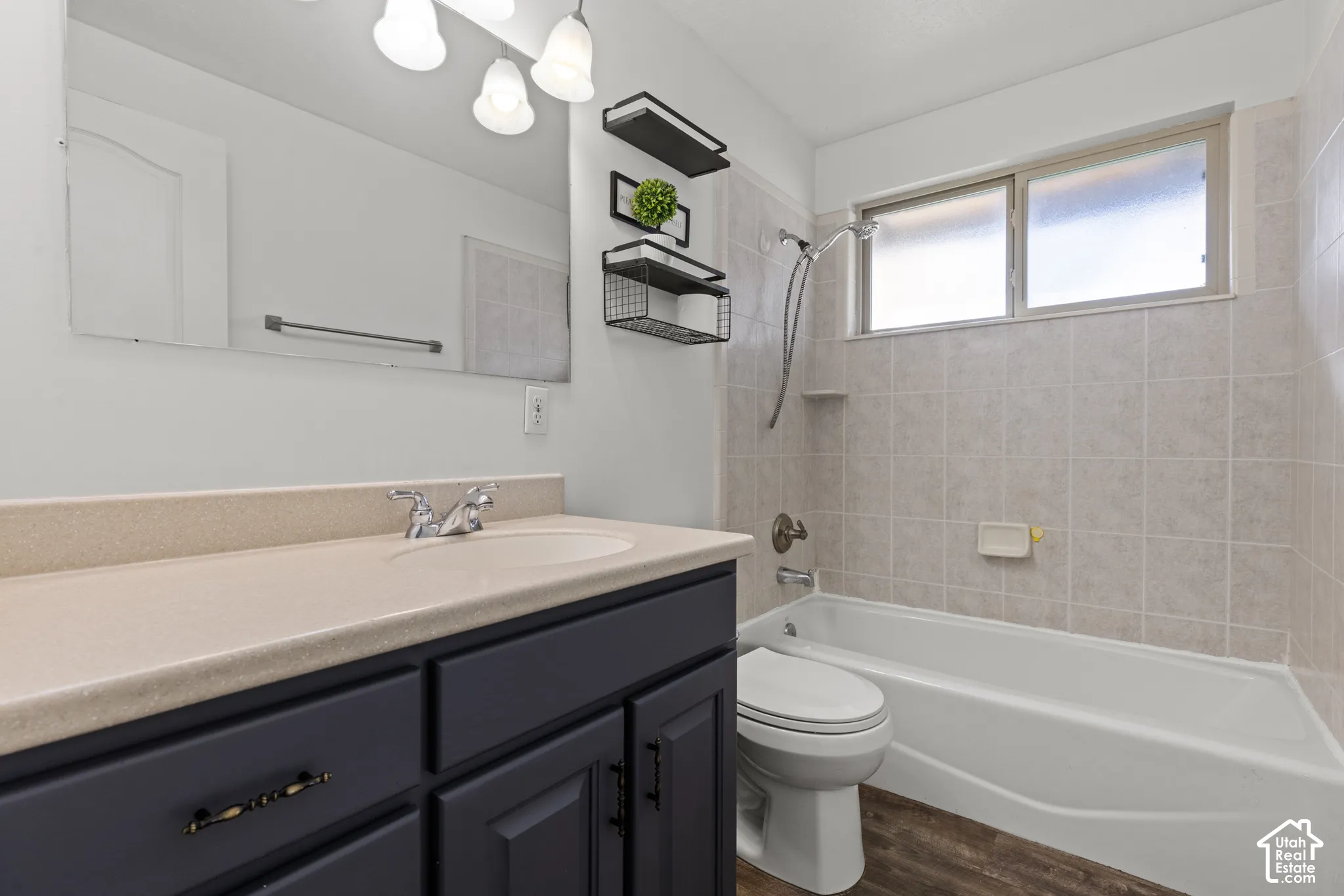 Full vanity with integrated sink, dark wood-finish cabinetry, and a full-width mirror
