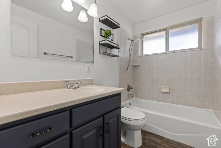 Full vanity with integrated sink, dark wood-finish cabinetry, and a full-width mirror