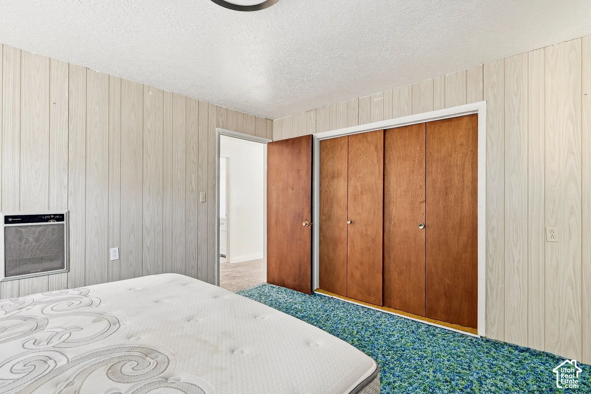 Paneled walls complement wood-finish sliding closet doors