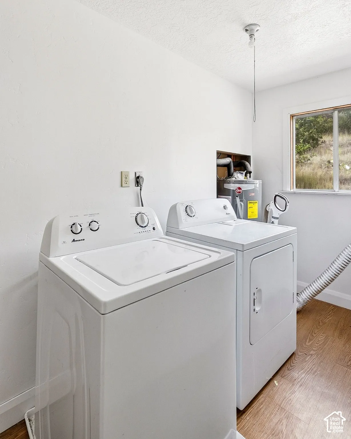 Laundry area featuring a top-load washing machine and front-load dryer