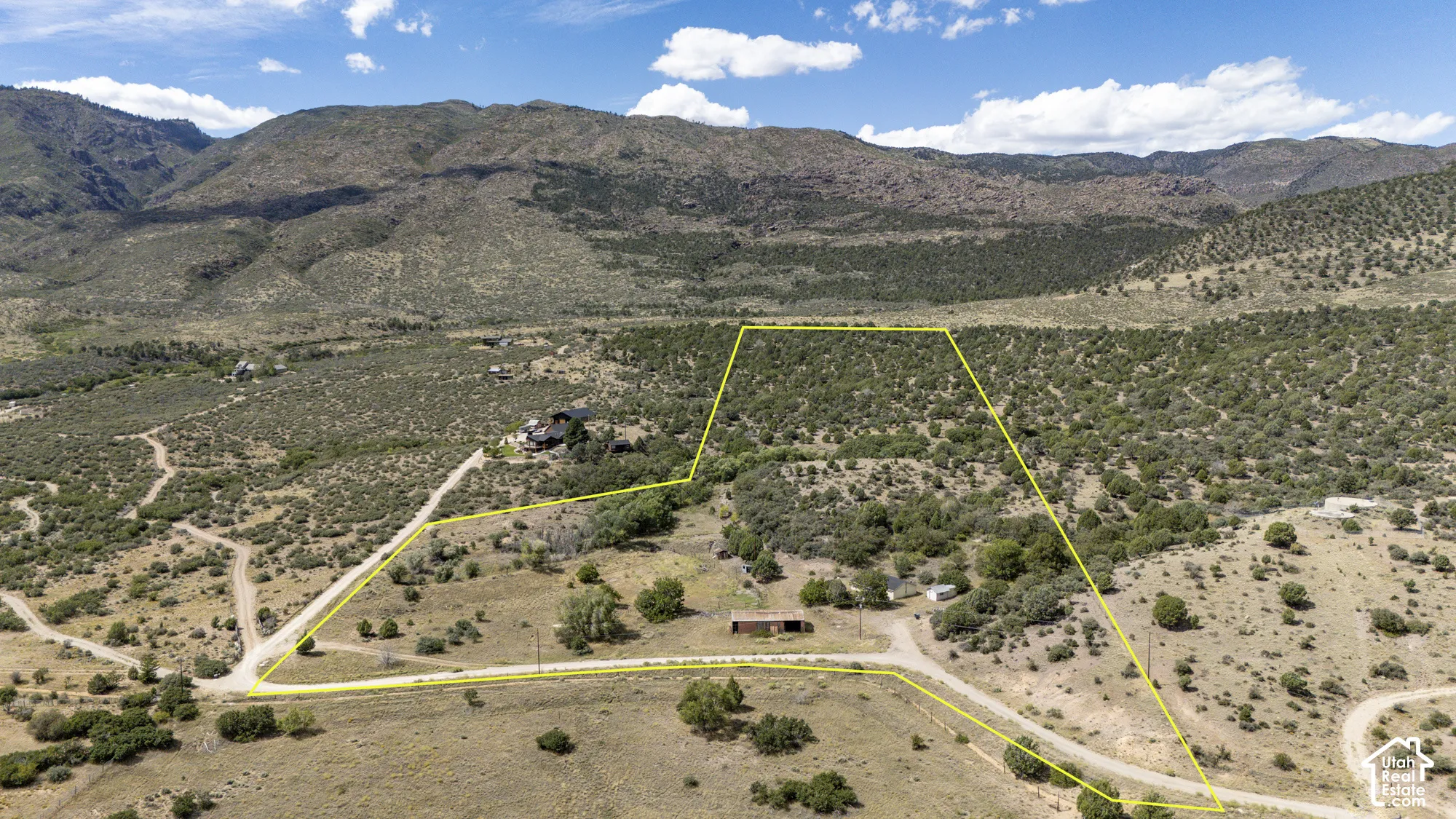 Expansive land parcel with surrounding mountainous terrain