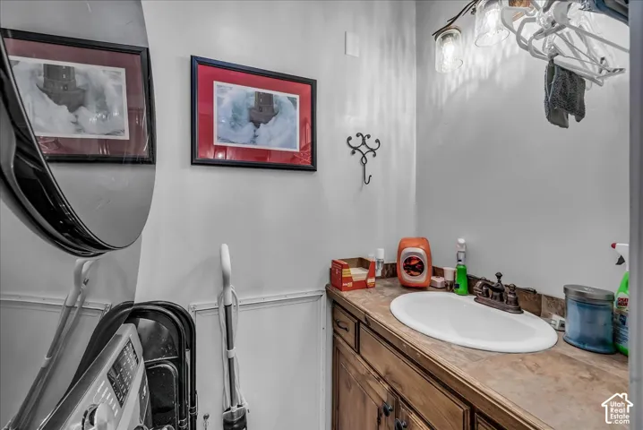 Vanity with an integrated sink, bronze-finish faucet, and coordinating wood-finish cabinetry