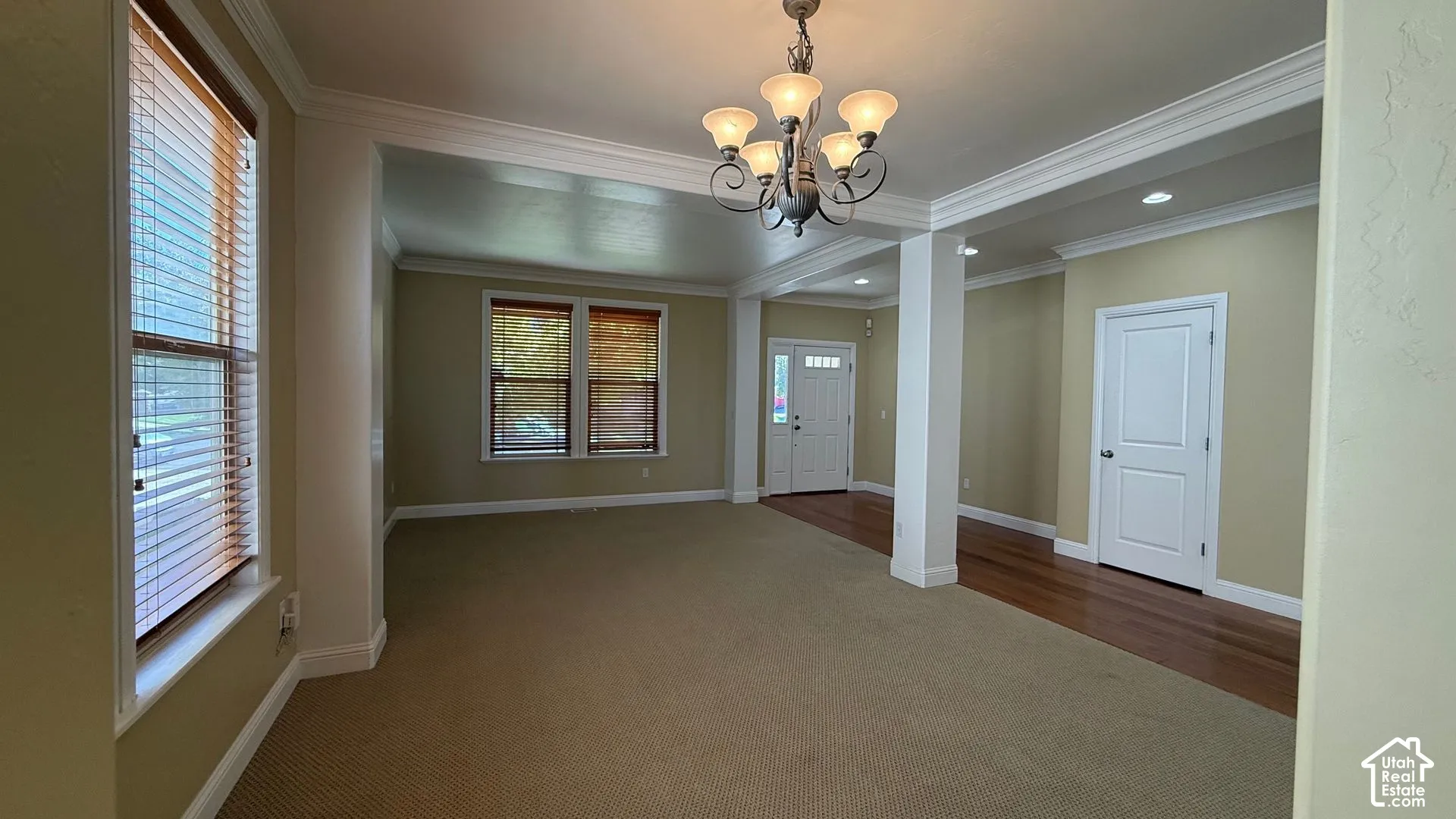Arched entryways featuring recessed lighting, a decorative chandelier, and crown molding