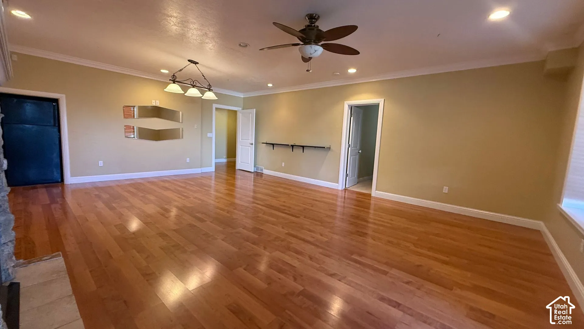 Hardwood flooring with recessed lighting, crown molding, and a ceiling fan