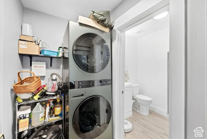 Stacked laundry appliances with light-toned flooring