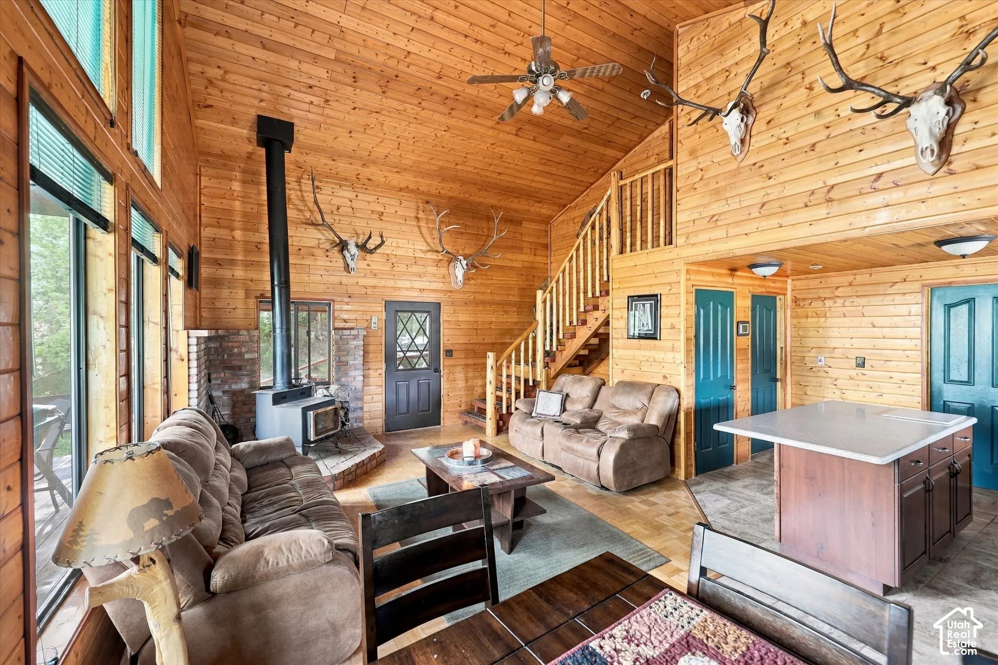 Vaulted wood-paneled ceiling with a ceiling fan