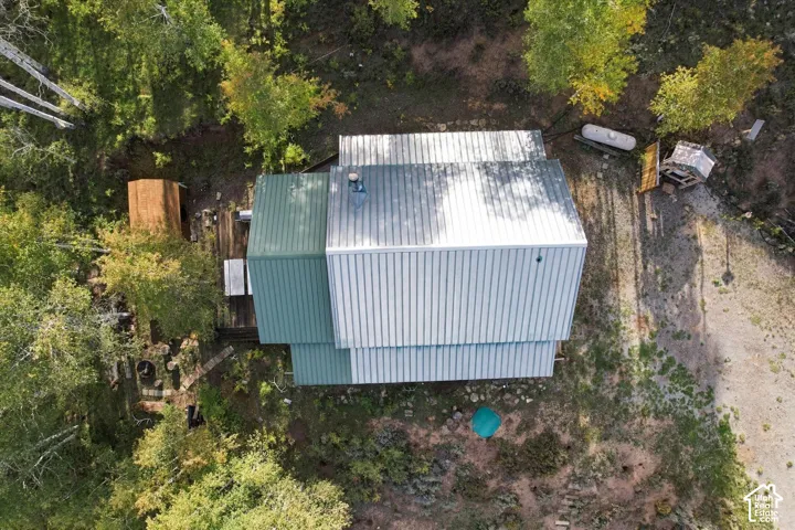 Metal roof structure with multiple pitches and dormers