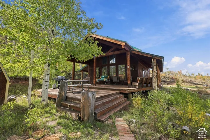 Wood-clad exterior with a green roof, expansive wood deck, and large picture windows