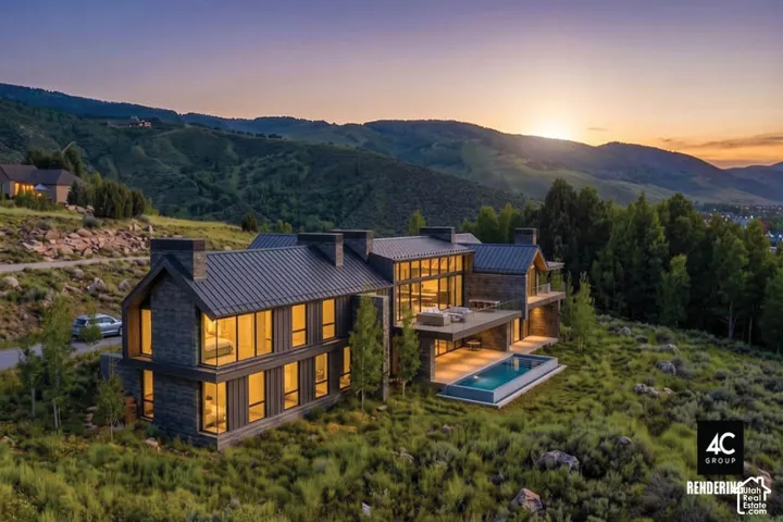 Modern architectural design featuring extensive window walls, stone exterior cladding, multiple patios, and an outdoor swimming pool