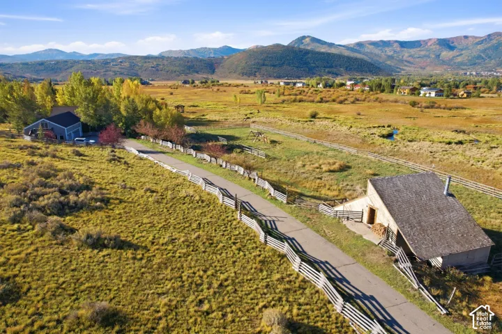 Ranch-style dwelling with a dark shingle roof and light siding