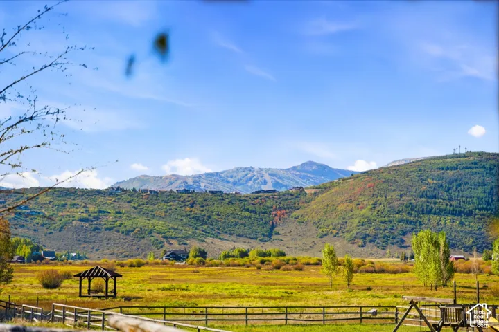 Expansive natural landscape featuring rolling hills and distant mountains