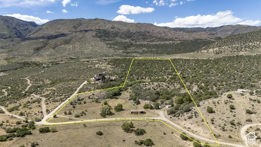 Expansive land parcel with surrounding mountainous terrain