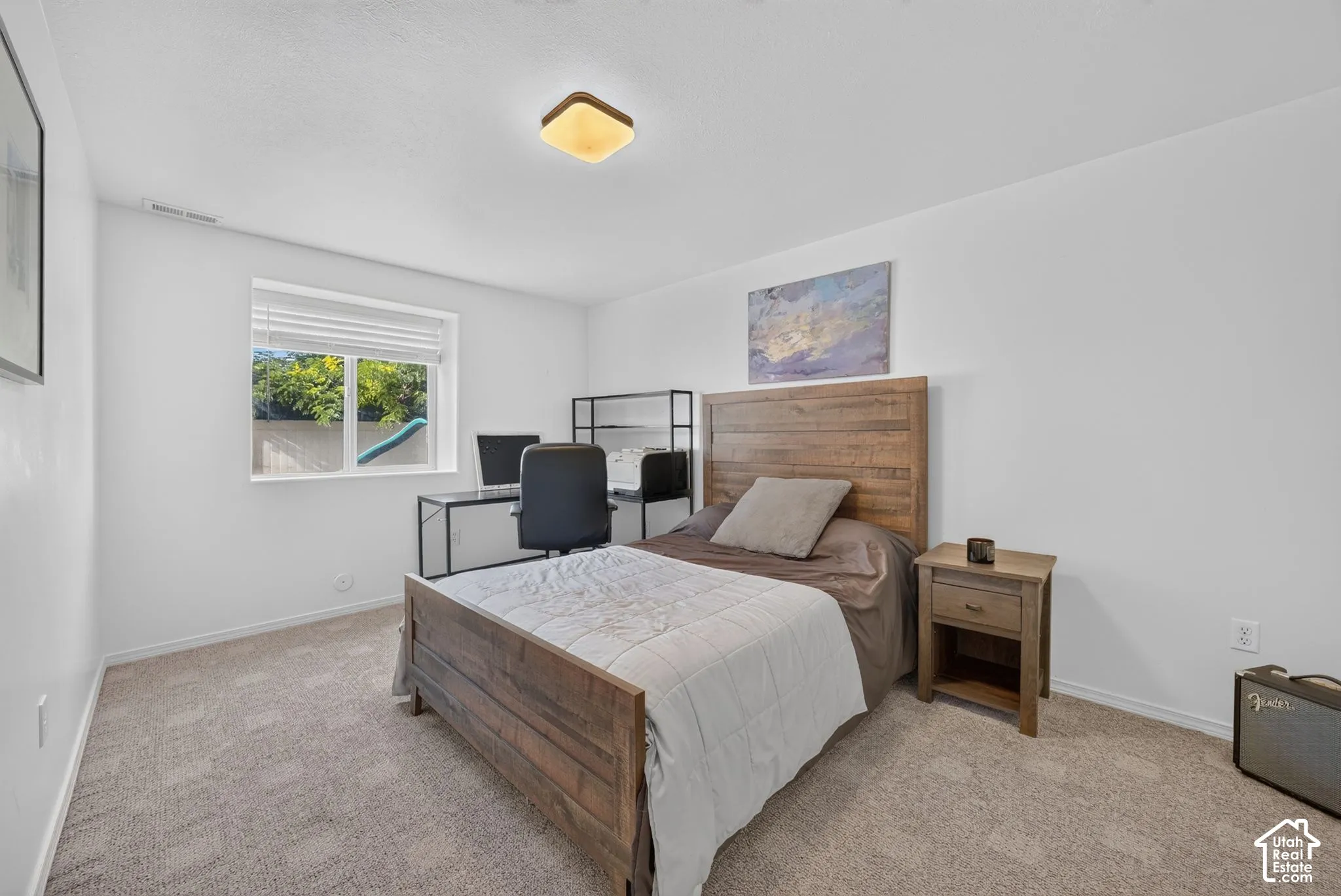 Neutral wall colors, carpet flooring, a window with blinds, and a ceiling-mounted light fixture