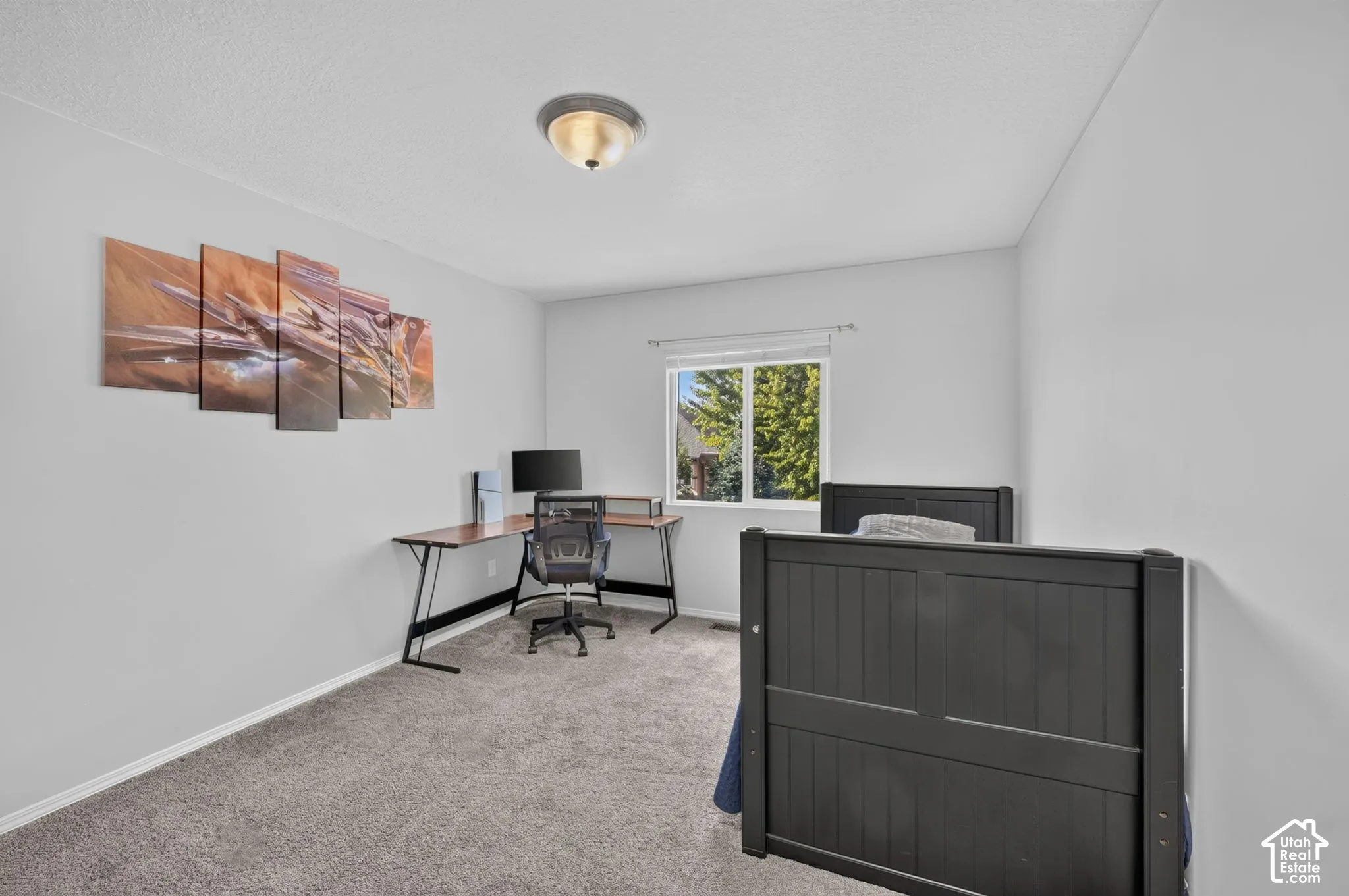 Window with outdoor foliage, wall-to-wall carpeting, and flush mount ceiling light