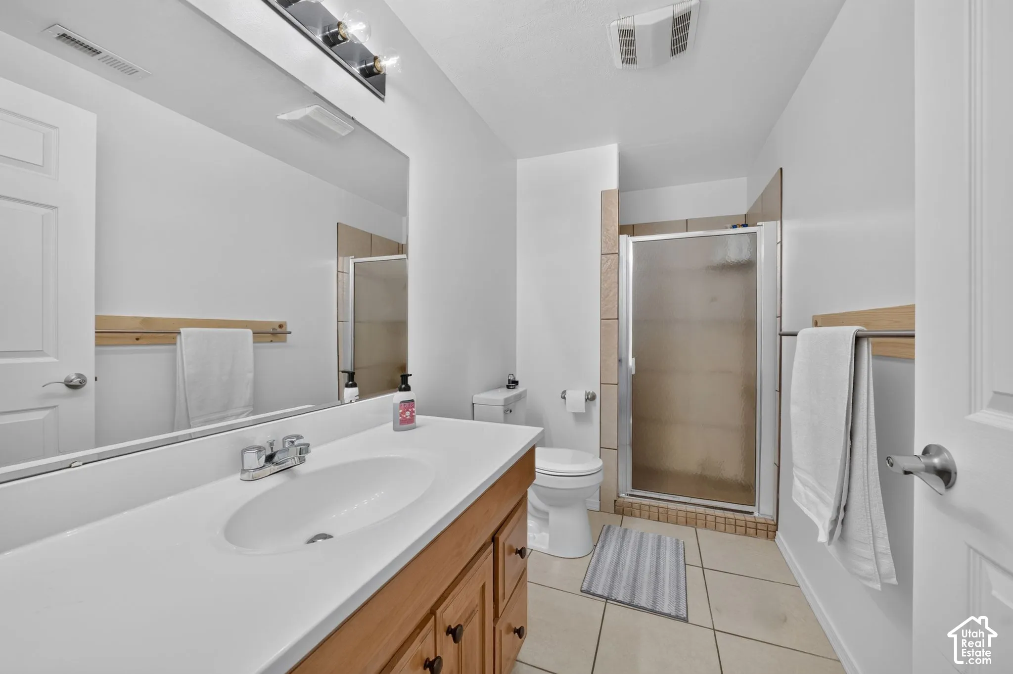 White countertop with an integrated sink and wood-finish cabinetry
