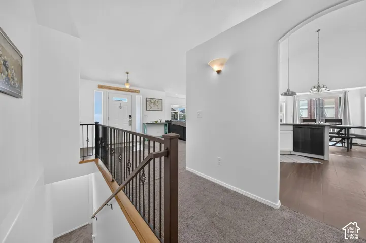 Staircase with wrought iron balusters and wood handrail