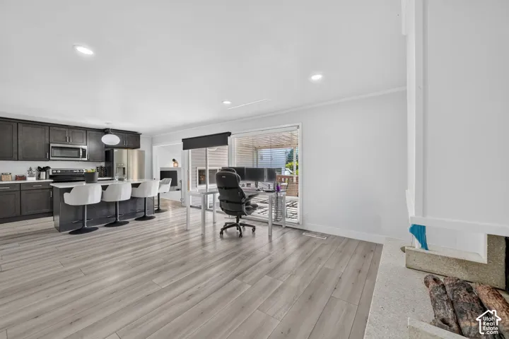 Modern kitchen with dark cabinetry, stainless steel appliances, and a central island