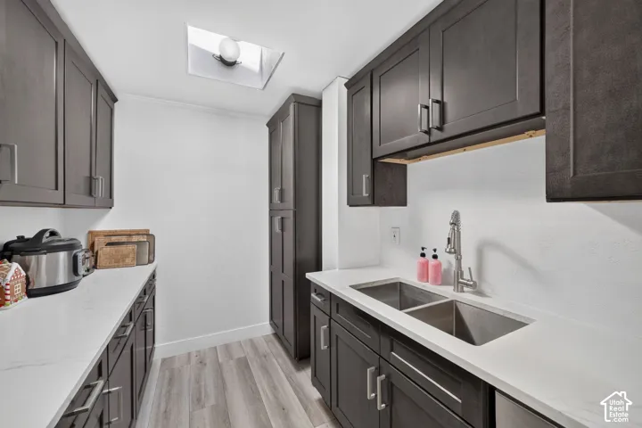White countertops with undermount double basin sink and stainless steel gooseneck faucet