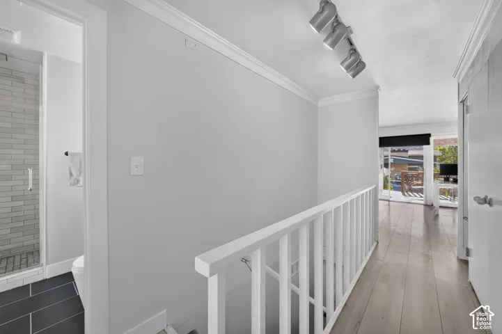 Wood-finish flooring throughout the hallway