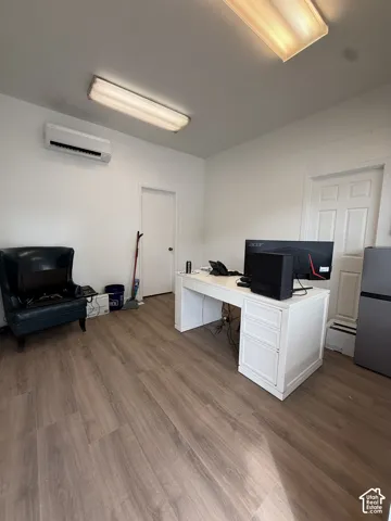 Wood-finish flooring, white walls, and bright overhead lighting