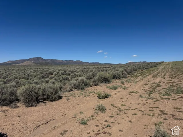 Expansive landscape with mountainous terrain and natural vegetation