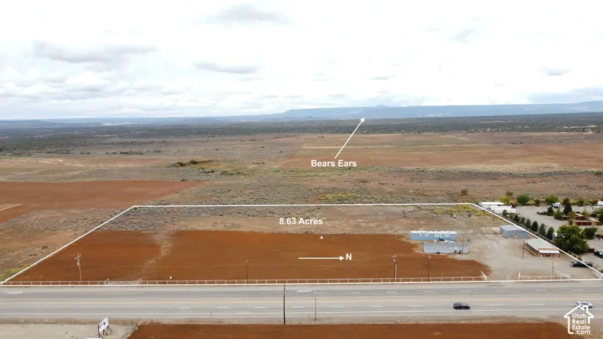 8.63 acres of land, featuring existing structures and direct road frontage