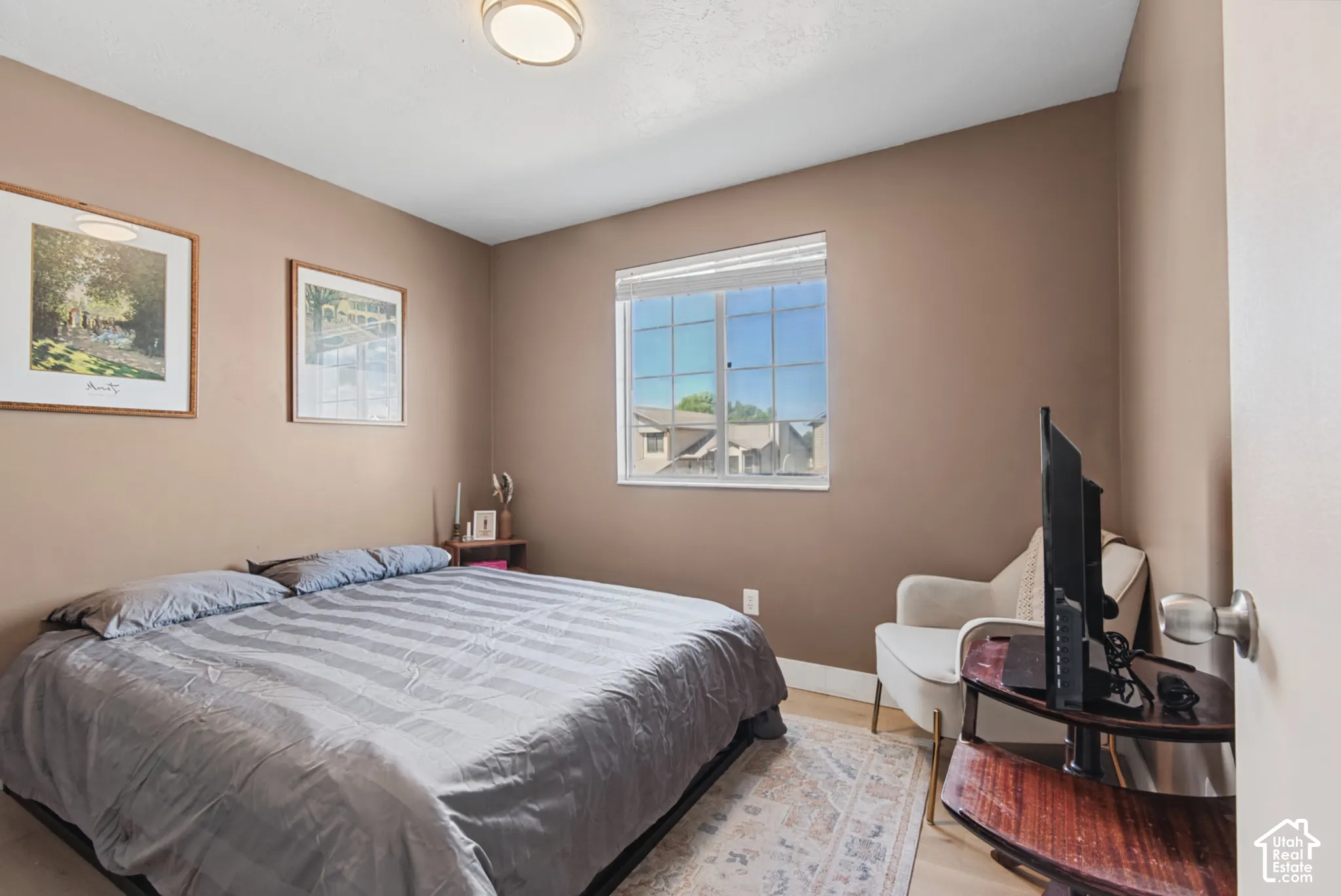 Recessed lighting, wood-finish flooring, and a large window with horizontal blinds