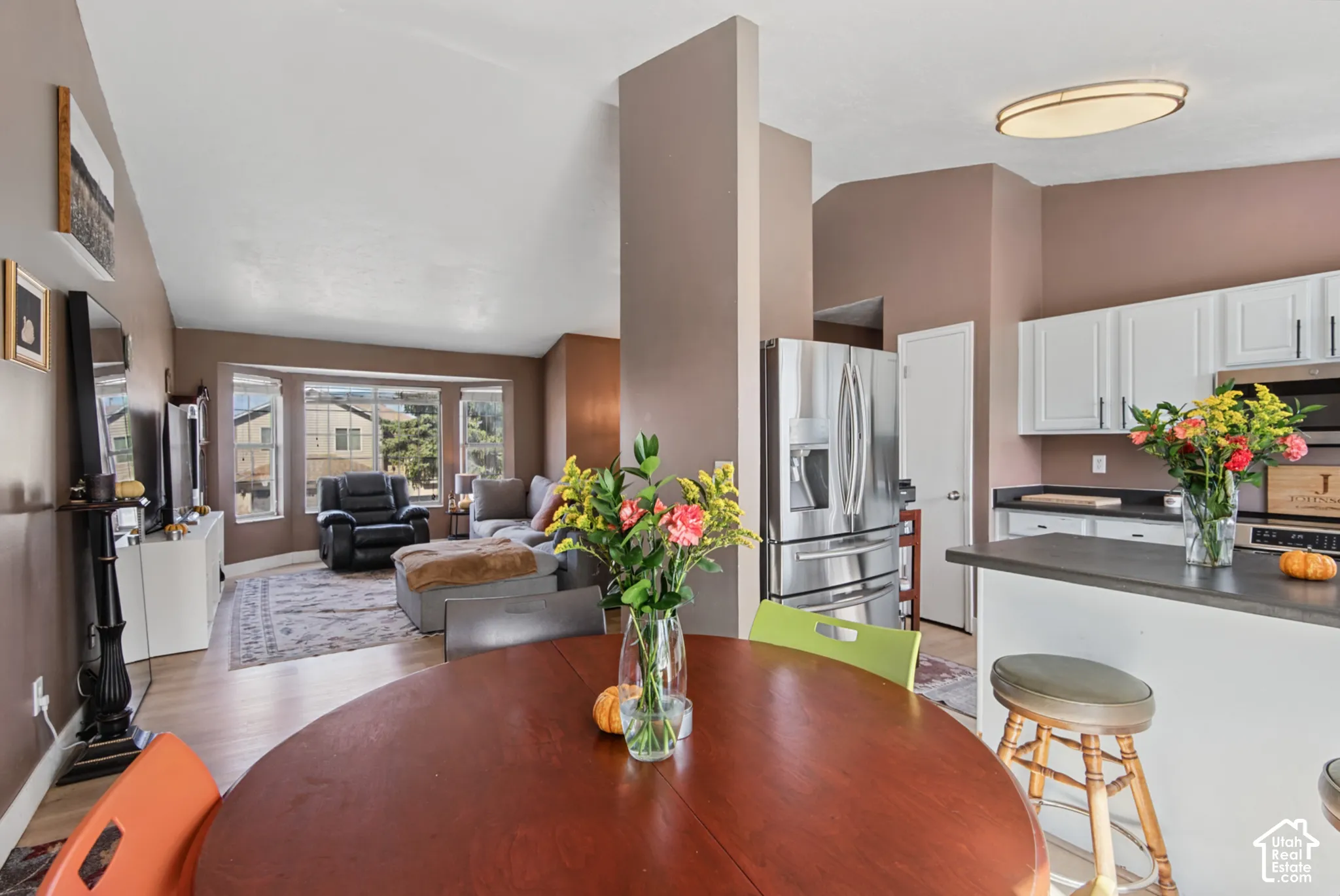 Recessed lighting, wood-finish flooring, and a bay window in the living area