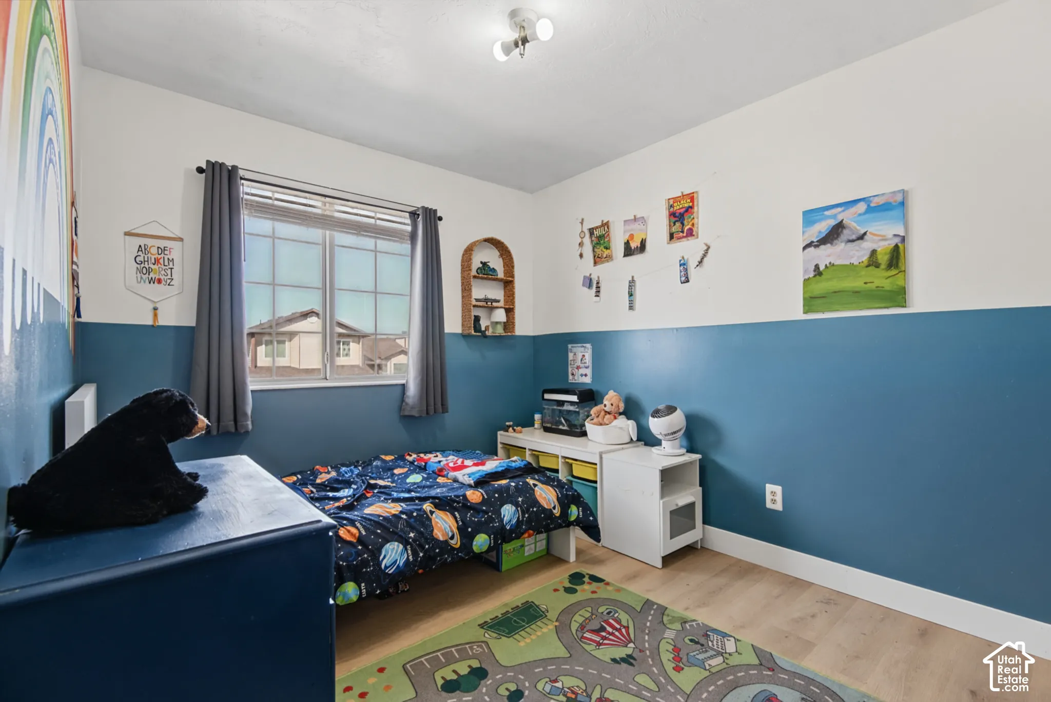 Light wood-finish flooring, a multi-pane window with blinds, and a built-in arched wall niche