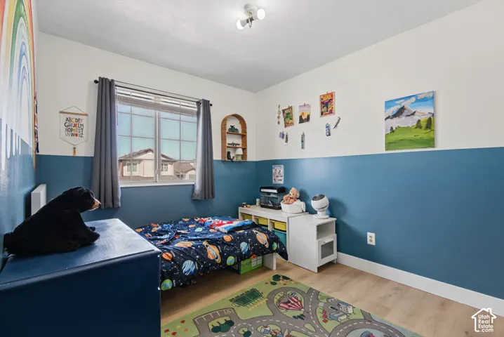 Light wood-finish flooring, a multi-pane window with blinds, and a built-in arched wall niche