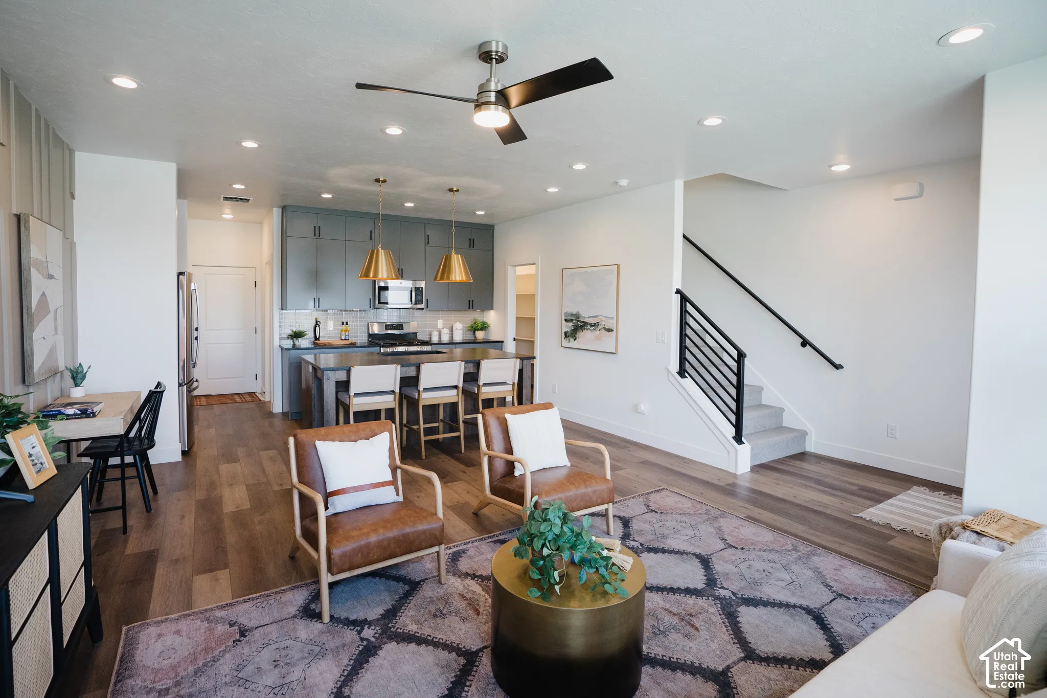 Open-concept living area featuring wood-finish flooring, recessed lighting, and a modern ceiling fan
