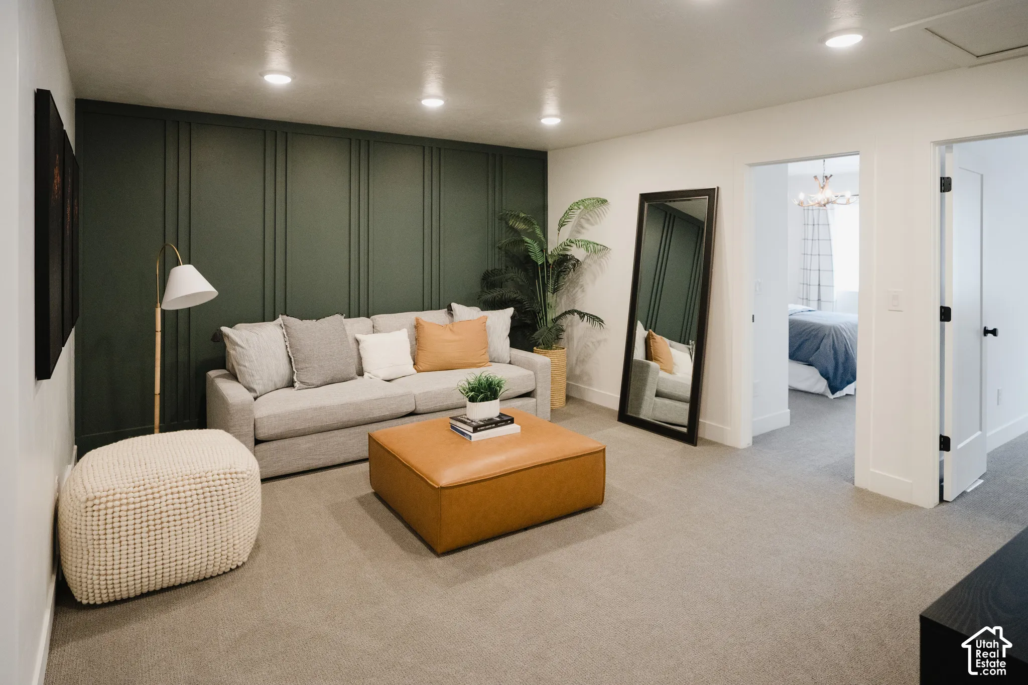 Wall paneling accent, recessed lighting, neutral carpeting, white interior doors, and a cased opening