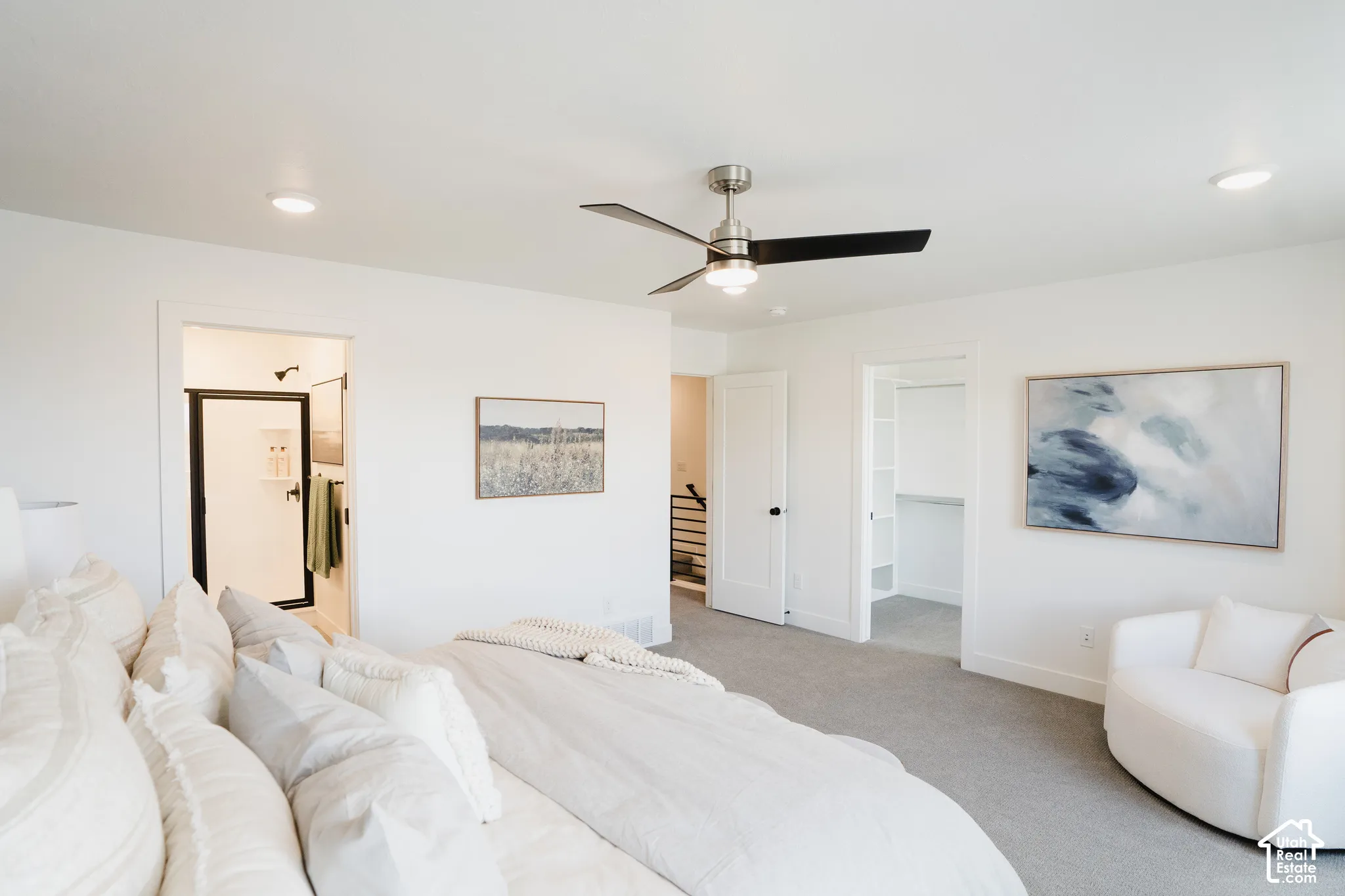 Recessed lighting, ceiling fan with light, plush carpeting, built-in shelving, and a shower with a dark-framed enclosure