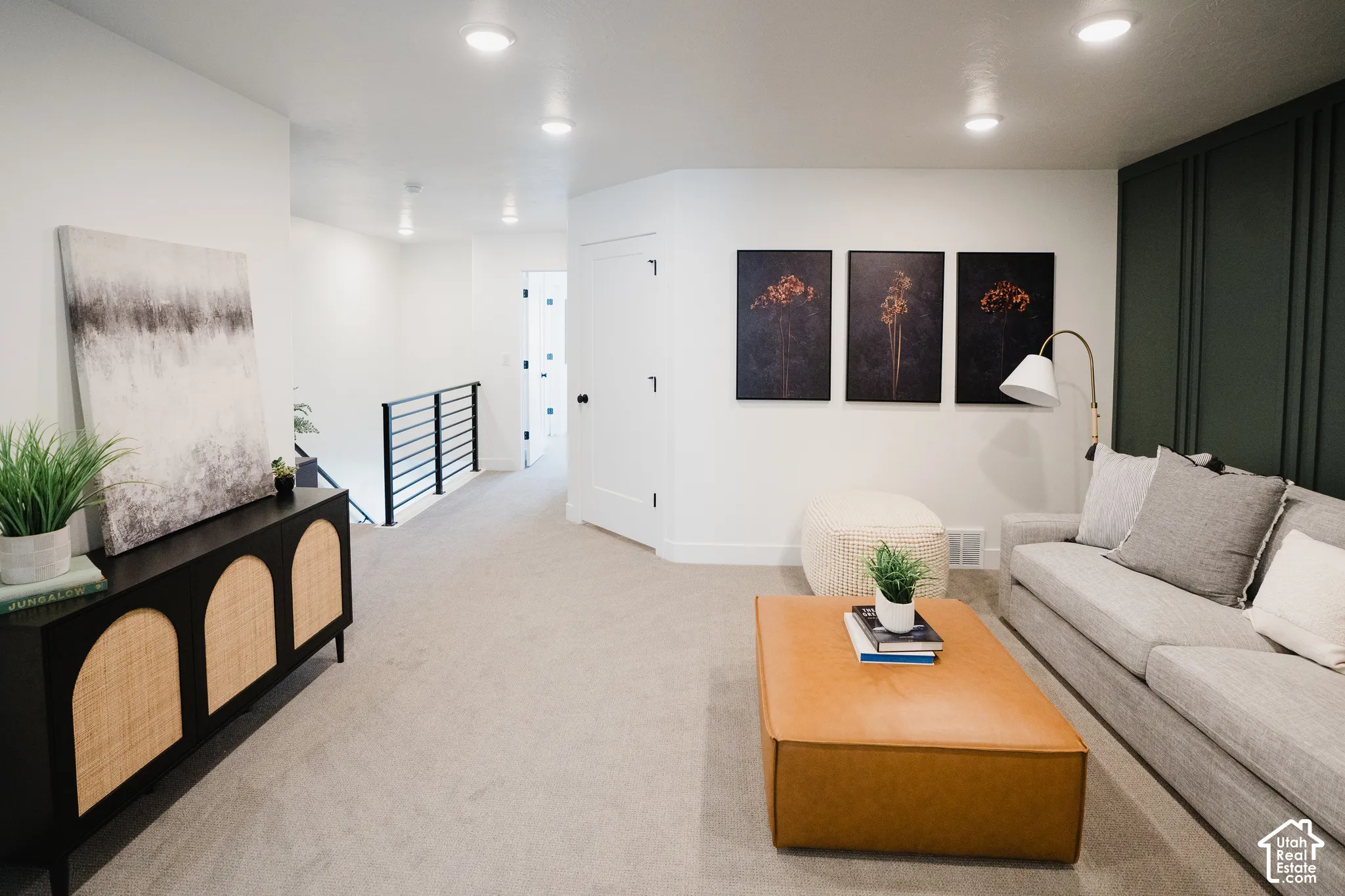 Recessed ceiling lighting, carpeted flooring, wall paneling, and white interior doors with black hardware