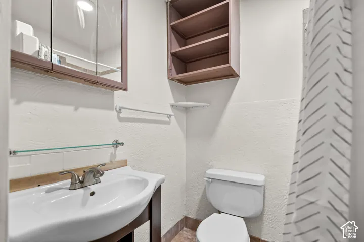 White vanity with an integrated sink and a brushed nickel faucet
