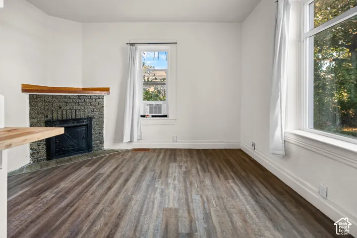 Wood-finish flooring with crisp white walls and substantial window trim