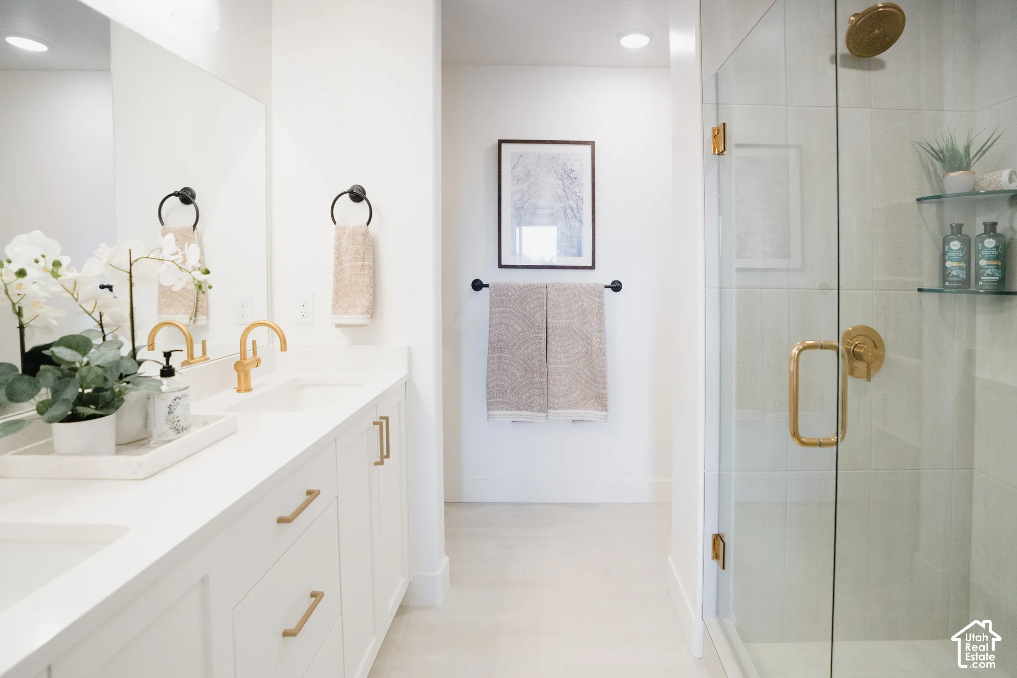 Dual sink vanity with gold-finish fixtures and hardware
