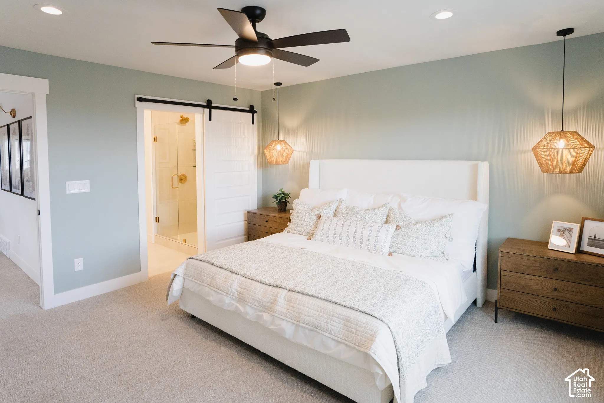 Recessed lighting, wood-finish ceiling fan, textured wall treatment, barn door entry, and glass-enclosed shower