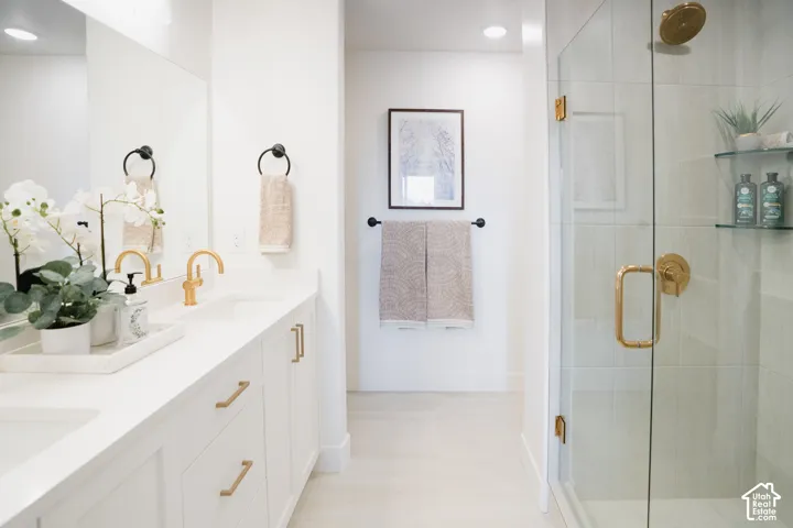 Dual sink vanity with gold-finish fixtures and hardware