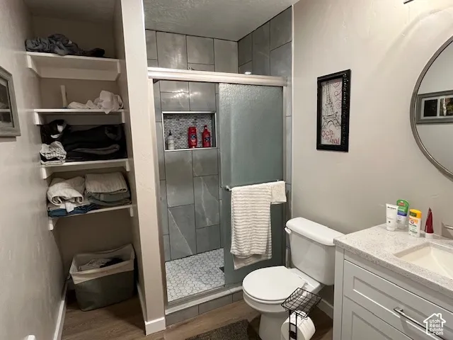 Shower with sliding glass enclosure, gray large-format wall tiles, and hexagon tile floor