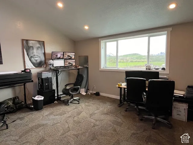 Room with sloped ceilings and recessed lighting
