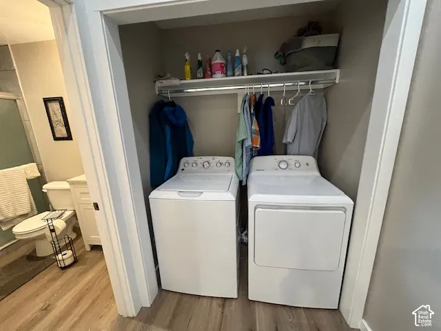 Dedicated laundry area with a built-in shelving unit and clothing rod